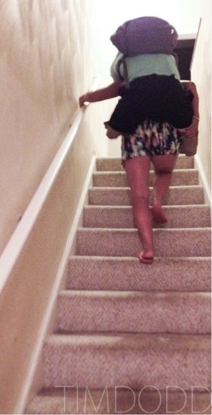 His girlfriend carrying Taylor Morris up a flight of stairs on her back