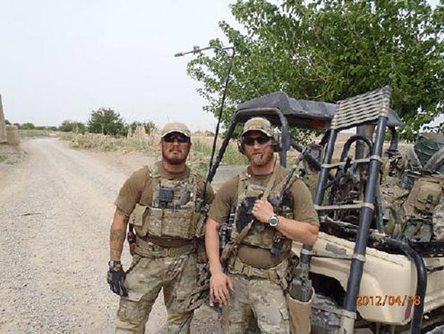 Taylor Morris and a teammate in body armor beside a stripped utility vehicle in Afghanistan, dated 18 April 2012