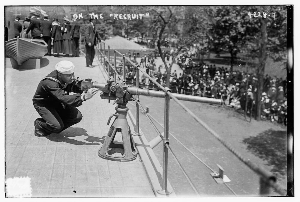 Sailor manning deck gun on USS Recruit