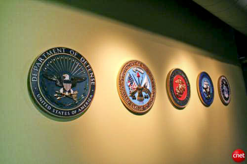 Wall of military insignia at the entrance to the Navy Command Center of the Future