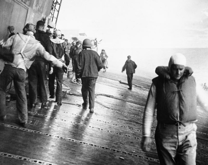 Crewmen on sloping flight deck of USS Yorktown after Battle of Midway June 1942