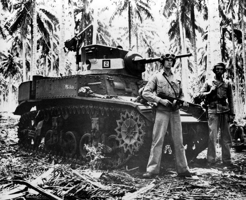 Two US Marines stand beside tank on Guadalcanal November 1942