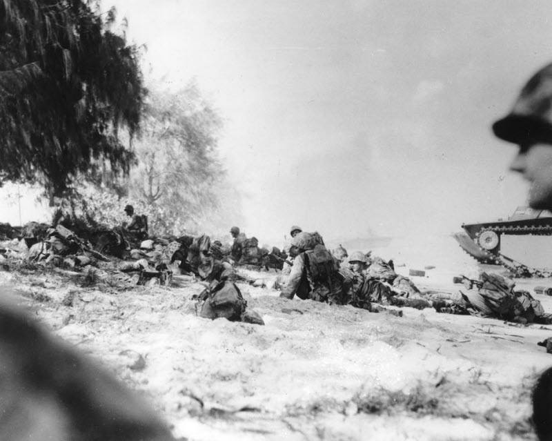 US Marines move up beach on Saipan under heavy machine gun fire June 1944