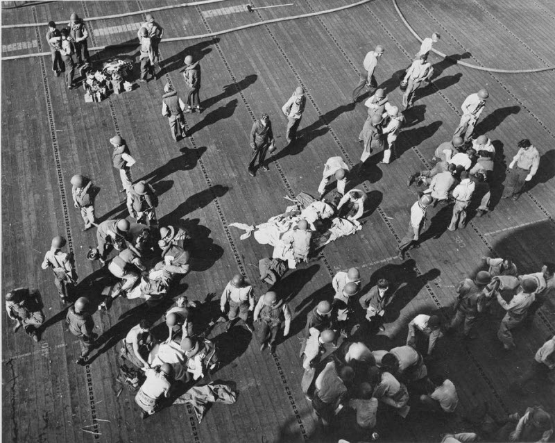 Wounded sailors treated on USS Intrepid flight deck after kamikaze attack November 1944