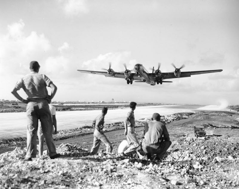 US soldiers watch B-29 Superfortress take off for raid on Japanese mainland from Saipan December 1944