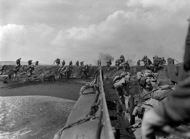US Marines hit beach and charge over dune on Iwo Jima February 19 1945