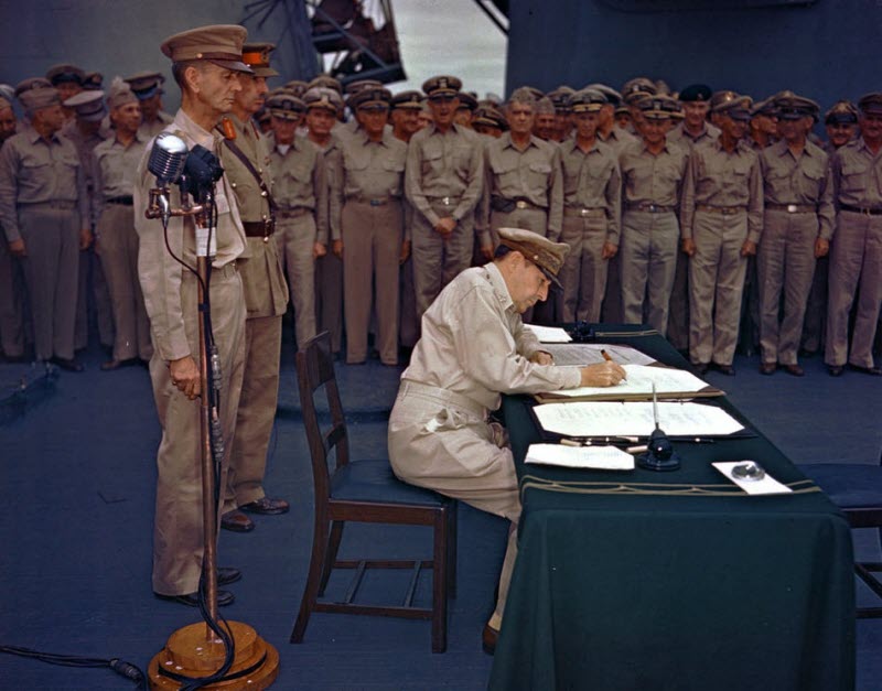 General MacArthur signs Japanese surrender documents aboard USS Missouri Tokyo Bay September 2 1945